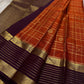 Cinnamon Kattam – Pure Kanchipuram Silk Saree
Vermillion red body with gold kattam checks & floral  buttas
Contrast plum purple korvai borders with rich zari weave
Grand zari pallu with lattice & floral motifs in gold
Silk Mark Certified ships in 2weeks
