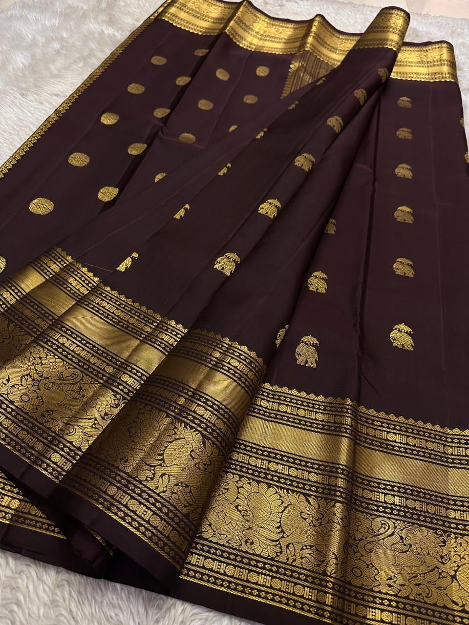 Handloom Kanchipuram saree in plum with gold zari motifs