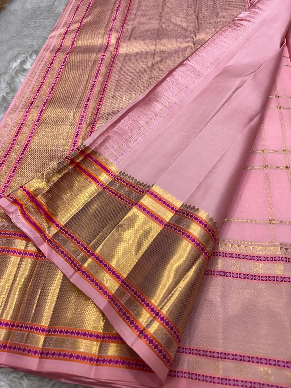 Pallu of blush pink Kanchipuram silk saree featuring rich gold zari panels and contrast pink temple borders – Idam Living