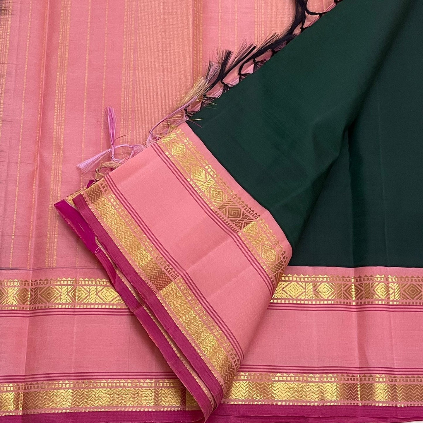 Close-up of rettapet gold zari border with geometric detailing on thamarai pink contrast edge