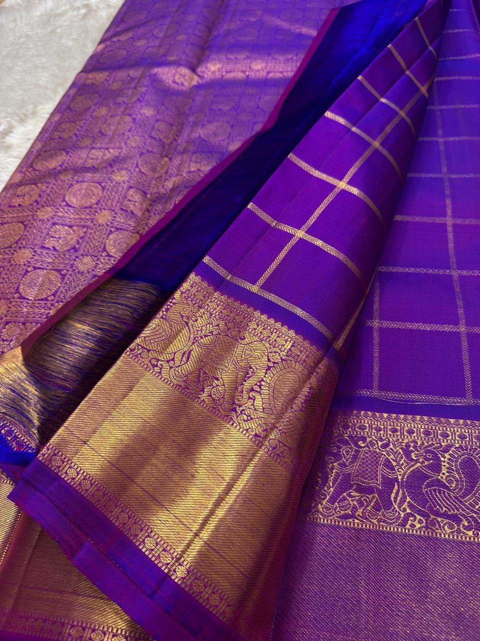 Leelavati Kattam
Amethyst Purple Kanchipuram Silk Saree
Zari-Woven Checks with Elephant Procession Border