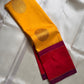Draped silk saree showing mustard yellow buttas, vermilion field and zari pallu details