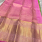 Full spread of pink zari woven pallu with ornate gold patterns and contrast green edge