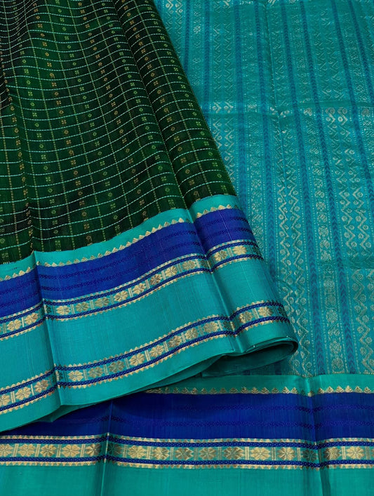 Lakshadweepam  kattam checks in bottle green ,  blue and teal  zari work with kamalam butta border