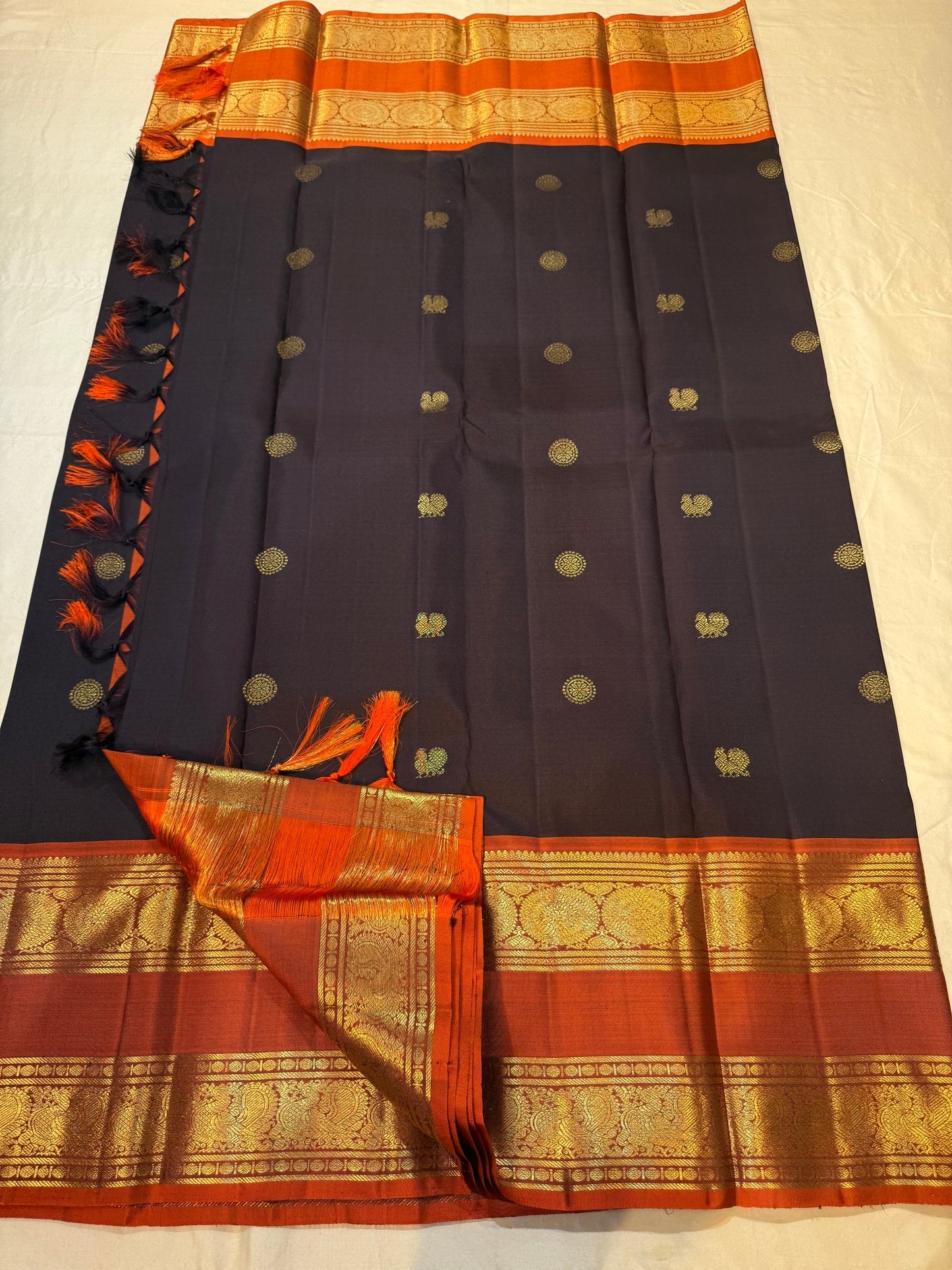 Dense gold zari pallu detail of dark charcoal and cinnamon red rettapet Kanchipuram silk saree — Idam Living