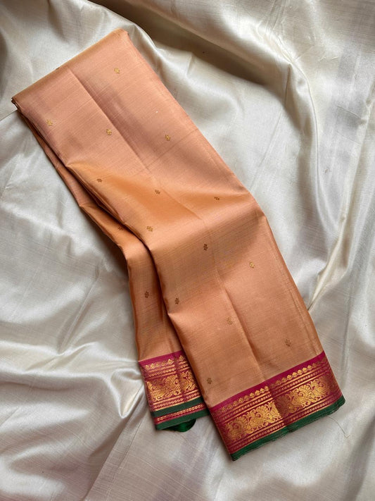 Pure silk kanchipuram Biscuit beige  color body with zari buttas , magenta mayil border with green selvedge