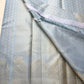 Chamomile — Kanchipuram Pure Silk

Pale gray-blue body with silver roopa buttas all over

Temple gopuram-inspired zari borders in luminous silver

Rich silver brocade pallu with intricate detailing

Silk Mark Certified • Free Shipping within USA