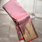 Rose Twilight — Kanchipuram Pure Silk

 Soft blush-pink (gulabi) body with gold floral buttas

Rosé-gold zari borders with floral vines & creepers

Vermilion-orange contrast pallu with kaddi & brocade panels

Silk Mark Certified | Free Shipping within USA