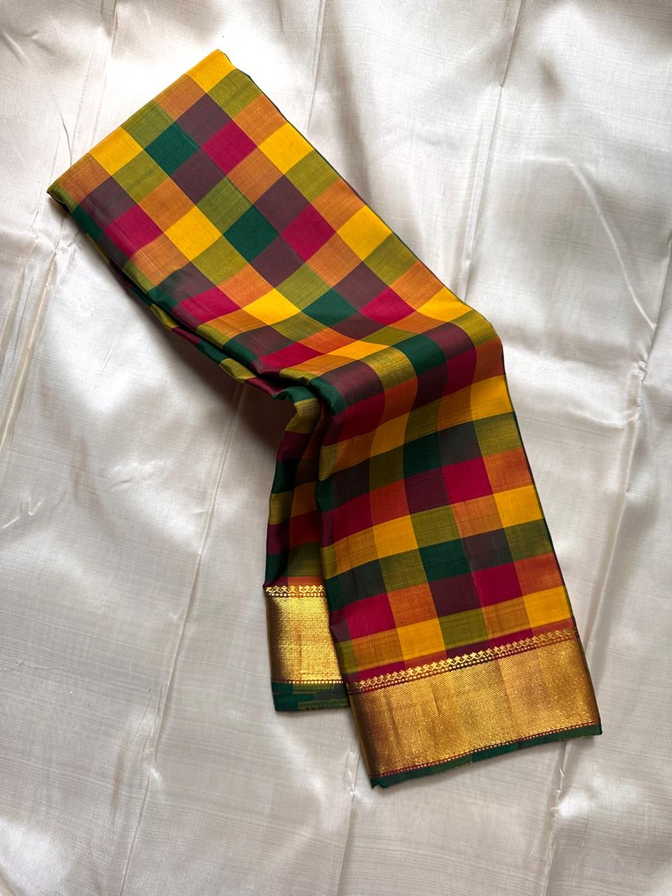 Draped Paalum Pazhamum checked silk saree showing mustard, green and maroon kattam with gold zari border