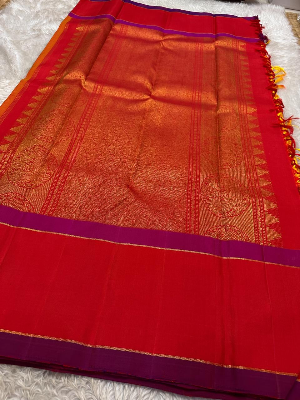 Close-up of vermilion silk body with magenta border and zari woven lines