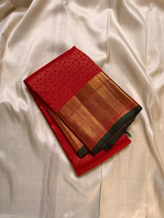 Kirtan ✨ – Vermilion Red Kanchipuram Pure Silk Saree
with Intricate Gold Zari Kattam Checks
Broad Lustrous Golden Border with Green Selvedge 🌿
Grand Radiant Pallu in Red & Gold Weaves
An Heirloom of Tradition, Festivity & Grace