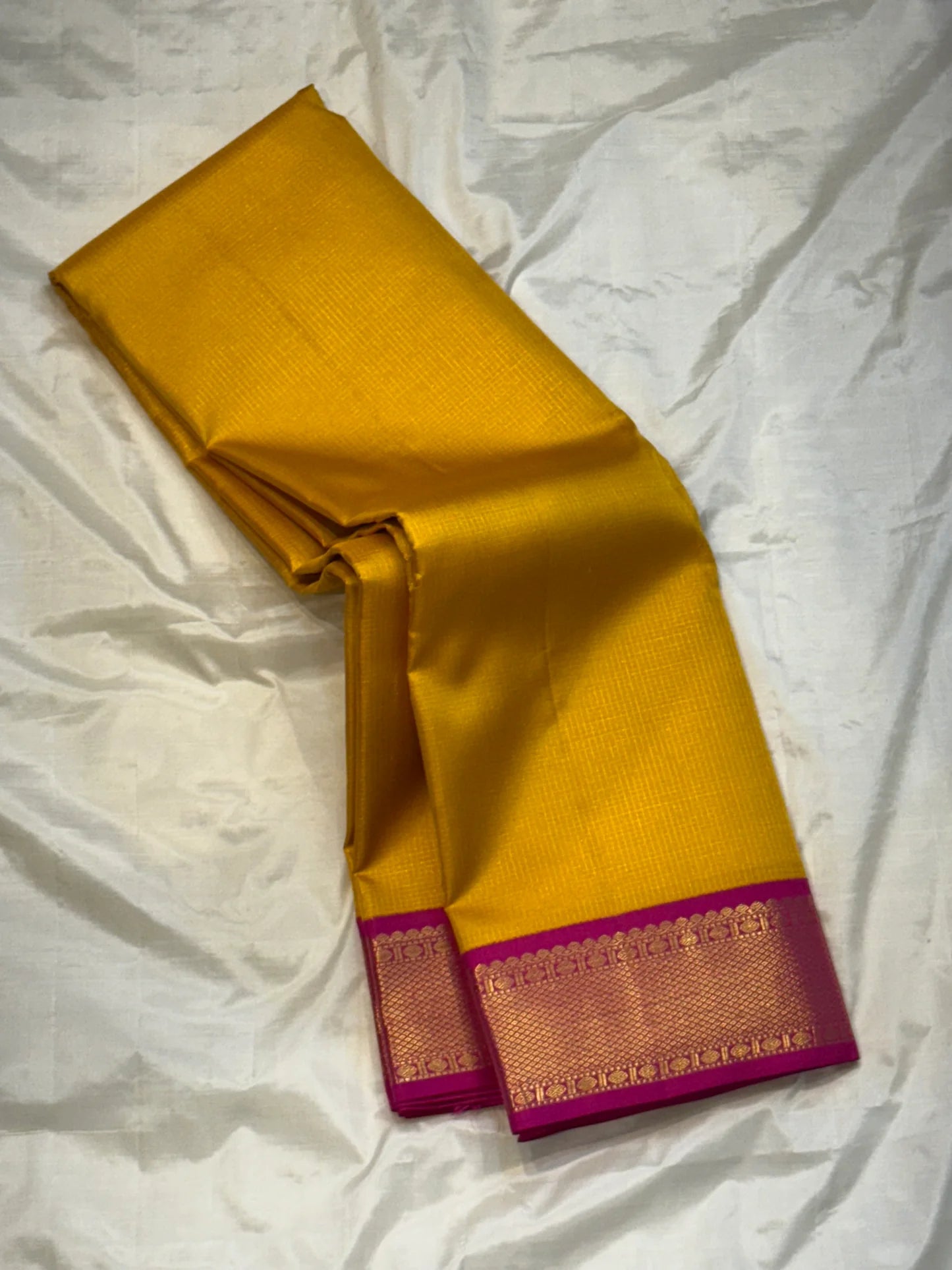 Ambar Rani — Pure Kanchipuram Silk Saree
Amber yellow oosi-kattam checks with contrast rani-pink korvai border and grand zari brocade pallu.
Silk Mark Certified • Free Shipping within USA • Ships in Two Weeks ✅