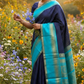 Indigo Teal Kattam – Pure Silk Kanchipuram Saree
Deep Indigo Body with zari Kattam Checks
Teal Contrast Korvai Border with maanga pet and mayil kann border, maanthulir selvedge  , silk mark certified -ships in two weeks