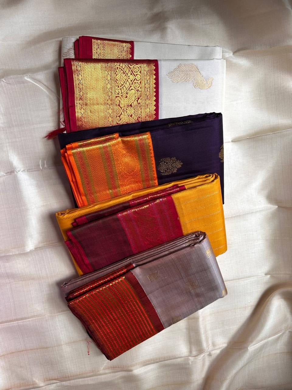 Jamun Purple Kesar – Korvai Kanchipuram Pure Silk Saree

Regal jamun-purple body adorned with antique-gold floral buttas

Kesari-orange korvai border with chakra roundels, vines & chevron zari

Free shipping withinUSA silk mark certified ships in 2 weeks