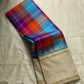 Venpattu Kattam Thazampoo Reku – ivory/venpattu borders with multicolor kattam (checks) body

Pure Kanchipuram silk • rani pink, tangerine, purple, sky blue & steel grey checks with thazampoo reku edging

Ivory pallu with gold tissue stripes & multicolor