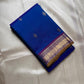 Sapphire Orchid celebrates the classic blue–purple pairing of Kanchi. The body is a rich sapphire/cobalt blue with tiny floral buttas in gold zari. A striking amethyst-purple korvai border and grid pavun Zari pallu Silk Mark Certified, delivery in 2 weeks