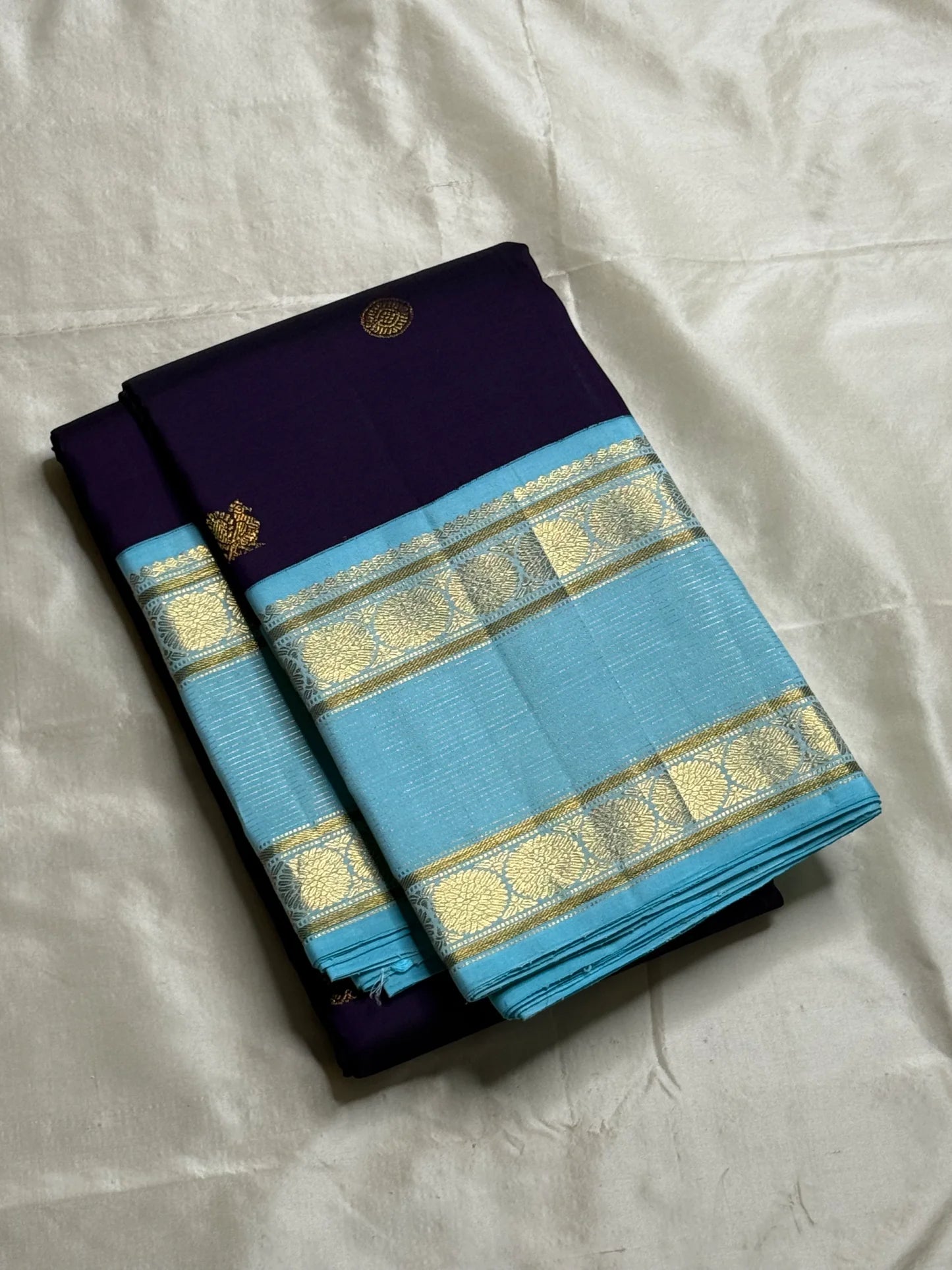Moora – Handwoven Pure Kanchipuram Silk Saree in Deep Regal Purple with Lustrous Contrast Aqua Blue Border and Grand Pallu, Featuring Intricate Gold Zari Weaving with Traditional Round Medallions, Paisley Buttas, and Concentric Floral Vine Patterns