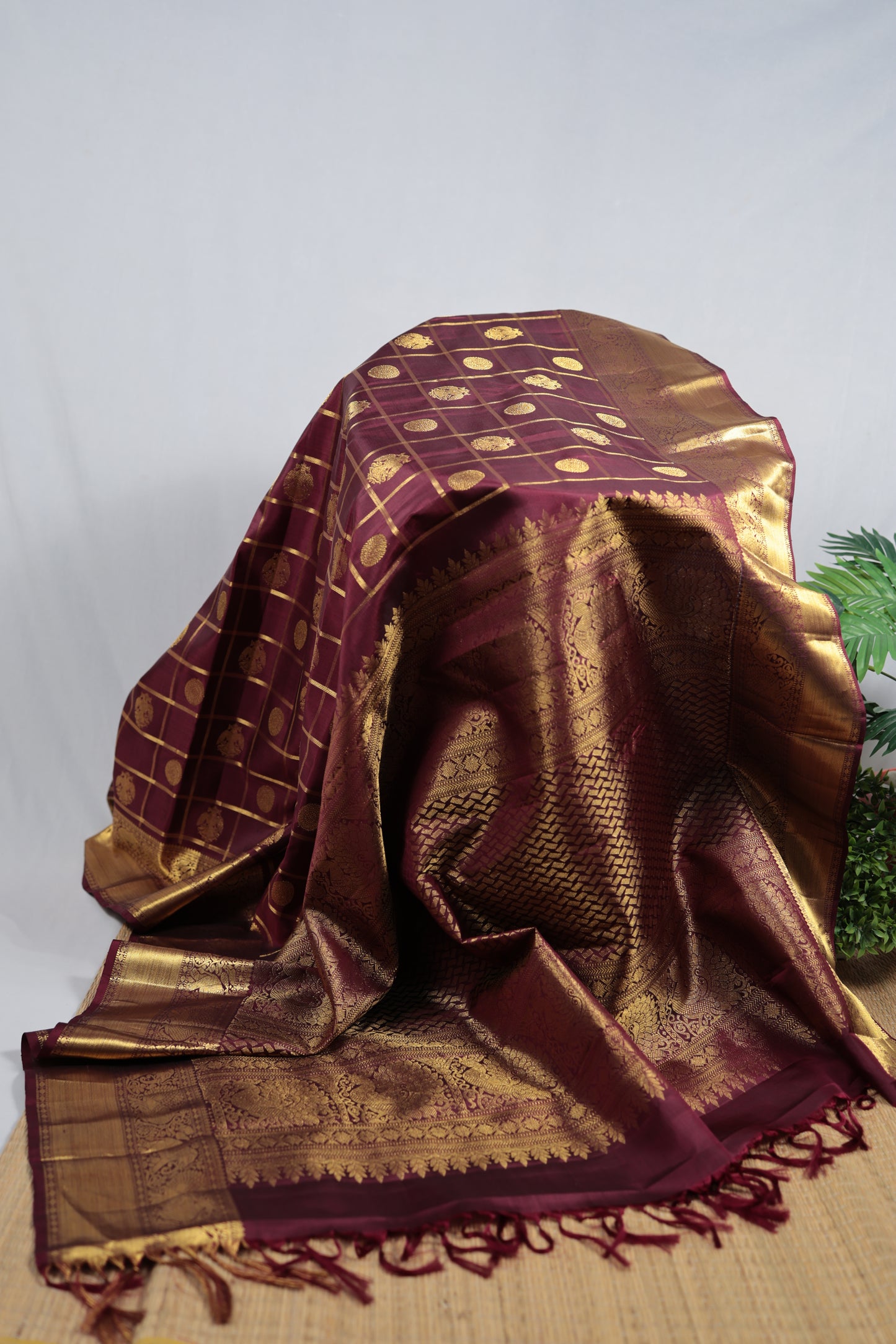 Wine plum pure silk Kanchipuram saree with gandaberunda butta detail and zari kattam flat lay
