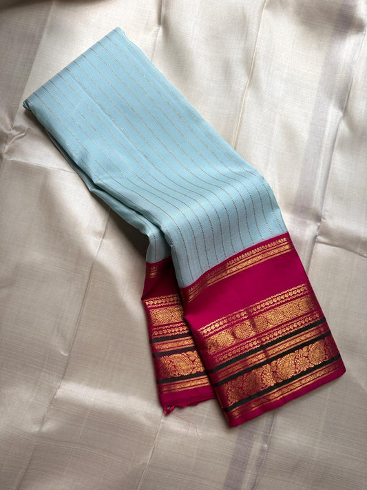 Orchid Sky ✨ – Pure Kanchipuram Silk Saree in Sky-Blue with Vertical Zari Stripes
Korvai Contrast Magenta Varisaipet Border & Grand Gold Zari Pallu
Contrast Magenta Blouse Piece with Matching Zari Border Attached
Silk Mark Certified | Fall & Pico Done |