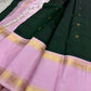 Full view deep green saree with lavender borders and gold zari detailing on bed