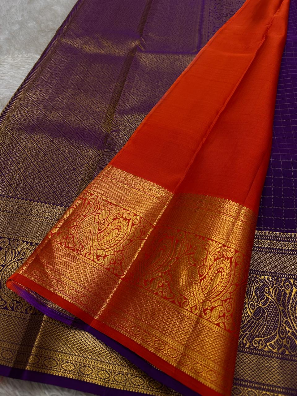 Aubergine Amber Kattam – Pure Kanchipuram Silk Saree
Deep Aubergine Purple Body with Gold Kattam Checks
Grand Zari Borders with Majestic Peacock Motifs
Contrast Amber-Orange Pallu with Rich Zari Detailing
Silk Mark Certified | ships in two weeks