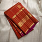 Pankajam 🌺 – Burnt Orange Kanchipuram Silk Saree with Zari Kattam, Dashed Lines, Kolam Motifs, Varisaipet Border with Thandavalam Zari Stripes, Rudrakshpet, Annam & Kamalam Motifs, Deep Magenta-Purple Selvedge & Ornate Pallu