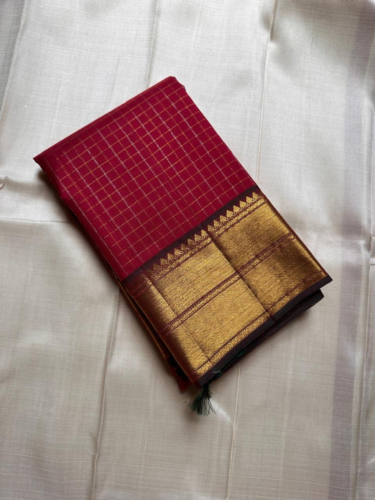 Ruby Zari Kattam – Pure Kanchipuram Silk Saree
Rich Ruby Red Body with Gold Zari Checks
Broad Golden Border with Maroon Highlights & Temple Motifs
Dual-Toned Maroon-Green Pallu with Intricate Zari Weaves

Silk Mark Certified, delivery in 2 weeks