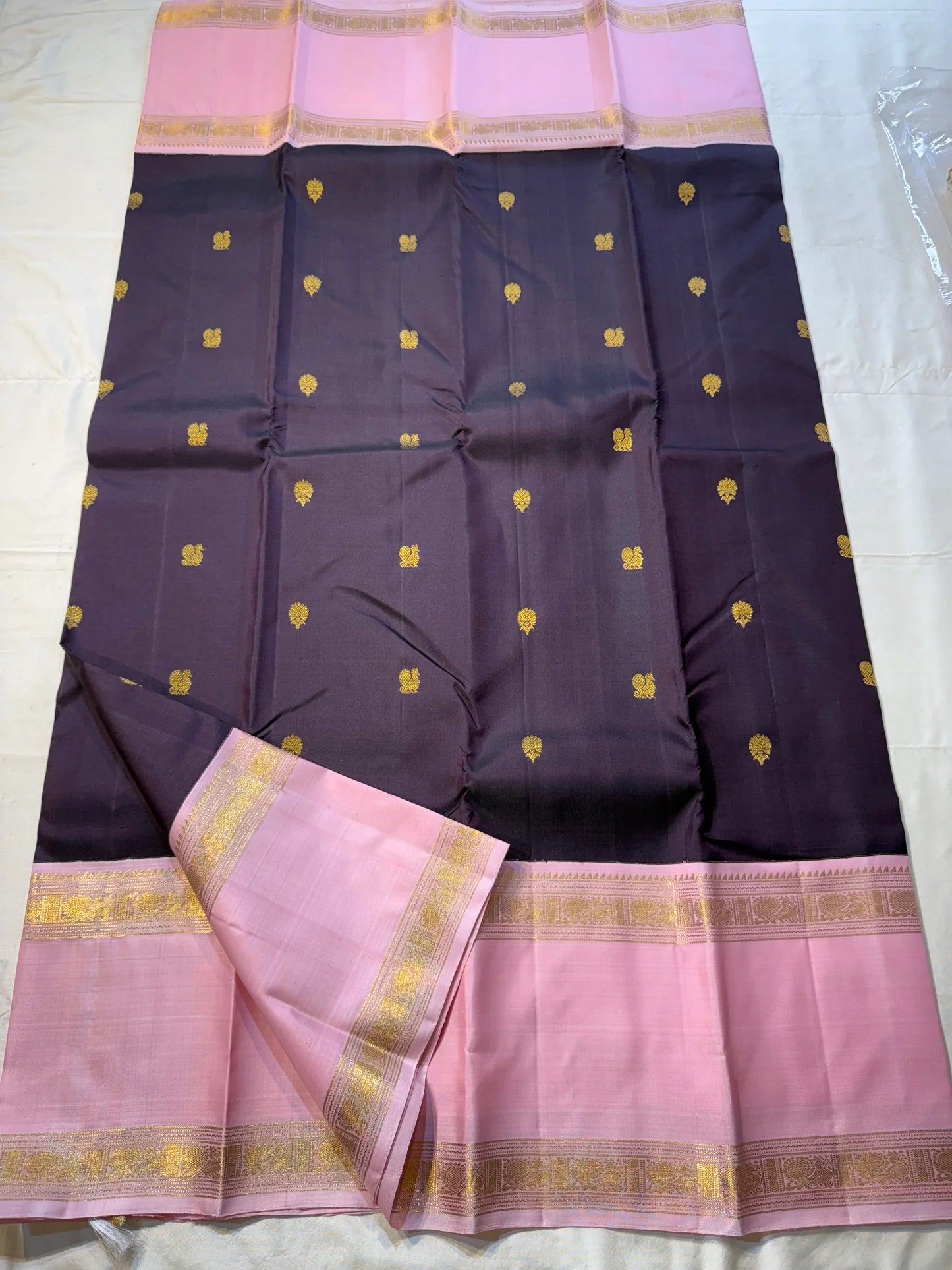 Rose Twilight – Pure Kanchipuram Silk Saree
Pastel Rose-Pink border with Golden Zari Weaves
Deep Plum-Violet Base Scattered with Gold Buttas
French Rose Rettapet Border in Lustrous Zari

Silk Mark Certified, delivery in 2 weeks