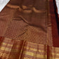 Gilded Rust – Pure Kanchipuram Silk Saree
Deep rust body with delicate paisley zari buttas 🌿
Antique-gold border featuring kaddi stripes & floral motifs ✨
Grand brocade pallu with lattice jaal & floral vines 🕊️

Silk Mark Certified, delivery in 2 weeks