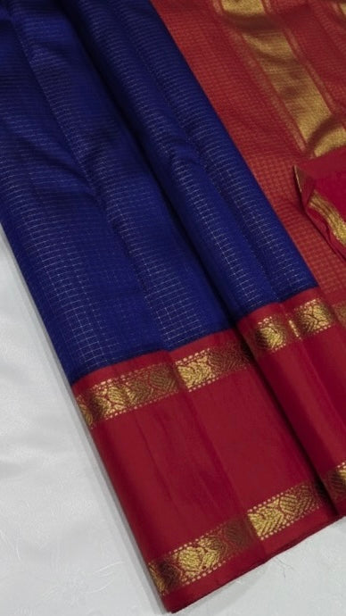 💎 Sapphire Rouge Oosi Kattam — Pure Kanchipuram Silk Saree
Royal sapphire-blue body with fine oosi-kattam checks and contrast rouge-red borders in antique-gold zari
Silk Mark Certified • Free Shipping within USA • Ships in Two Weeks •