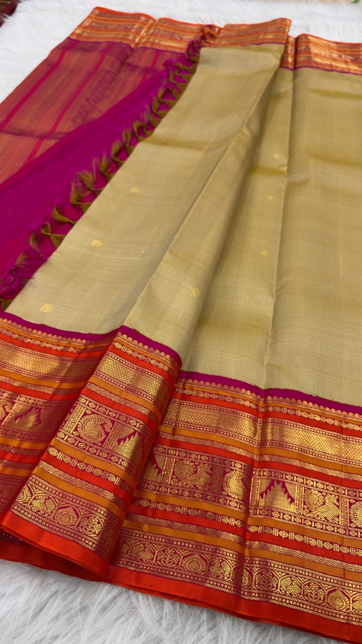Muted Olive Gold pure silk Kanjeevaram Varisaipet saree with Rani Pink and orange gold zari border.
