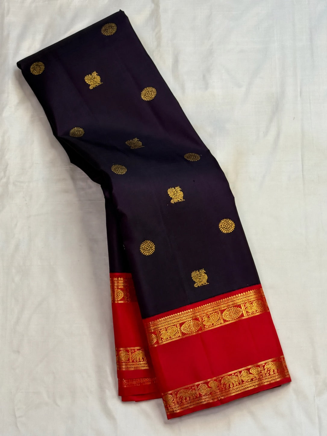 Peacock motifs in zari on a deep violet Kanjeevaram silk saree