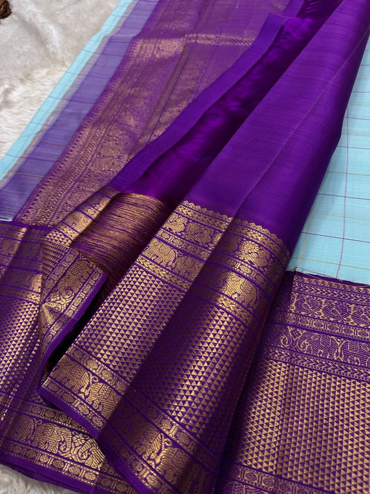 Aqua Amethyst zari kattam Pure Kanchipuram Silk Saree with blue Checks & Purple Border
Radiant sky-blue silk woven with delicate golden checks.
Grand purple korvai borders with elephant and floral motifs.

Silk Mark Certified, delivery in 2 weeks
