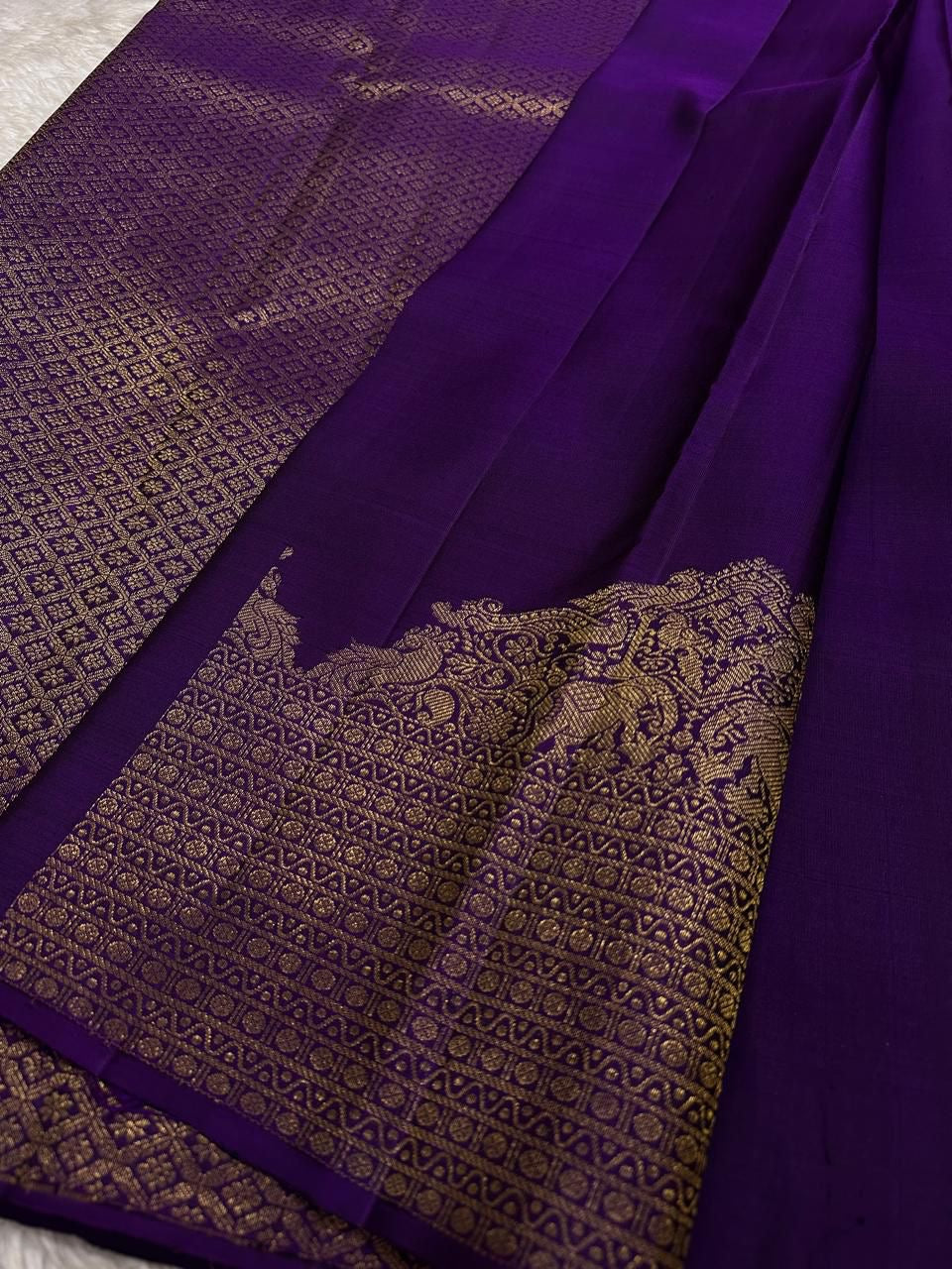 Lotus Glow — Violet | Pure Kanchipuram Silk Saree
A royal violet canvas with antique-gold zari peacocks, elephants & lotus motifs ✨
Silk Mark Certified • Free USA Shipping • Ships in Two Weeks