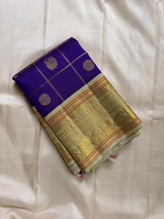 Amethyst Mayil Chakram – Pure Kanchipuram Silk Saree
Zari Kattam Checks with Peacock Motifs
Deep Violet Body with Golden Zari Detailing
Light Green Borders with Paisley Weaves

Silk Mark Certified, delivery in 2 weeks