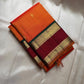 Orange Maragatha Korvai — Kanchipuram Pure Silk

Sunset aruna-orange body with delicate single zari butta

Deep maroon korvai borders with floral rosette motifs; green selvedge

Rich maragatha-green zari pallu (zari jaal & vine panels)..description