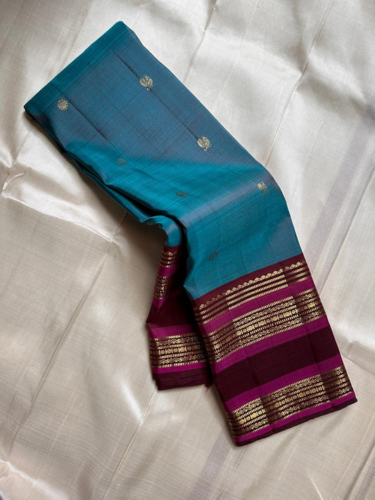 Neelam Jamuna – Pure Kanchipuram Silk Saree

A teal body adorned with glowing zari buttas.

Wine korvai border detailed with antique-gold.

A majestic jamuna pallu rich in brocade artistry.

Silk Mark Certified, delivery in 2 weeks