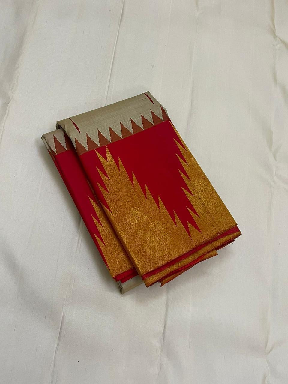Vermillion Venpattu Ettukol — Pure Kanchipuram Silk 
Ivory venpattu body with fine red temple -motifs in ettukol weaving 

Vermilion-red &gold korvai temple (reku) borders

Mullai moggu woven motifs on body  

Silk Mark Certified | Free Shipping within US