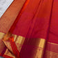 Agnika – Tomato orange shot Red Kanchipuram Silk Saree with Mayil Chakram Butta & Orange Border
Fiery and regal, Agnika is a pure Kanchipuram silk saree featuring a rich red body adorned with intricate Mayil Chakram buttas.