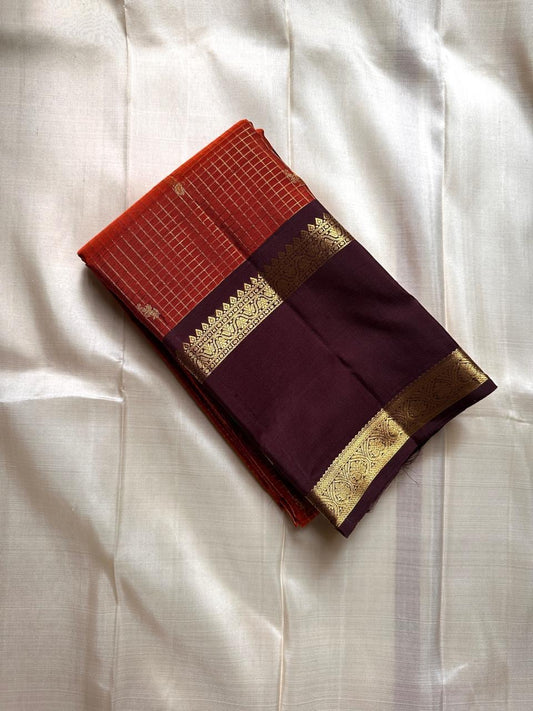 Gilded Rust Kattam – Pure Silk Kanchipuram Saree

Rust-orange kattam (checks) body with petite zari buttas ✨
Deep brown  korvai border with intricate gold zari design 🌸
Grand zari-rich pallu 💛
Silk Mark Certified ✅ | ships in two weeks