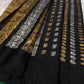 Lavanya – Black Handwoven Kanchipuram Silk Saree with Gold & Silver Zari

A timeless black Kanchipuram silk saree with intricate gold and silver zari motifs — Gandaberunda, parrots, elephants, and lotuses — exuding regal elegance.