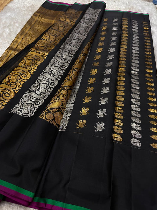 Lavanya – Black Handwoven Kanchipuram Silk Saree with Gold & Silver Zari

A timeless black Kanchipuram silk saree with intricate gold and silver zari motifs — Gandaberunda, parrots, elephants, and lotuses — exuding regal elegance.