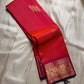 Sharvani – Orange & Magenta Pure Silk Kanchipuram Saree
Featuring zari-woven stripes across the body for subtle structure.
Bold magenta border with rice reed and peacock motifs, finished with a green selvedge.