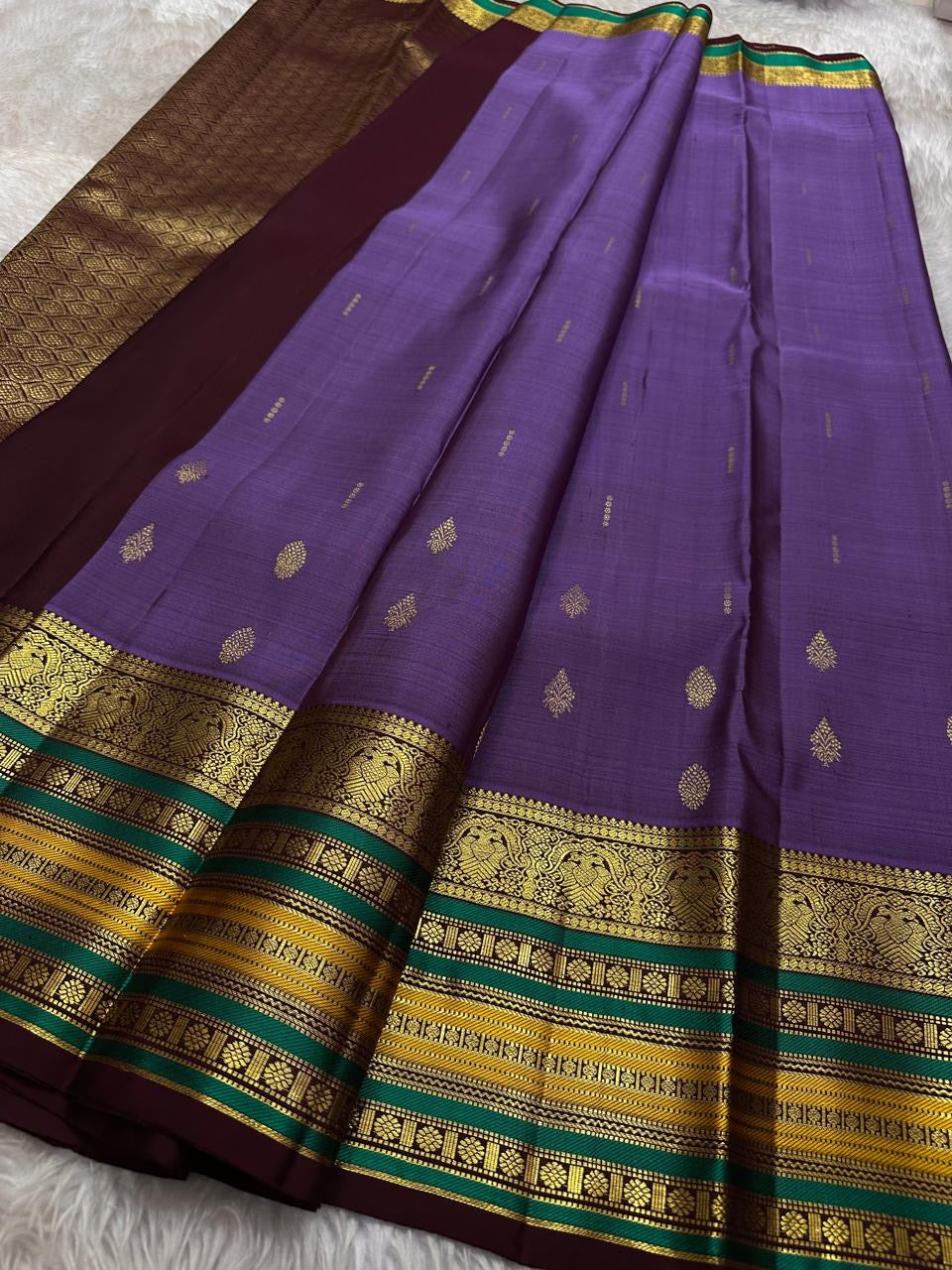 Kaamini ✨ — Purple Pure Kanchipuram Silk Saree
With Elegant Brown Korvai Border & Bold Stripes
Adorned with Scattered Gold Zari Buttas on Body
Intricate Zari Weaving in Regal Brown Pallu
Contrast Blouse with Matching Korvai Border
