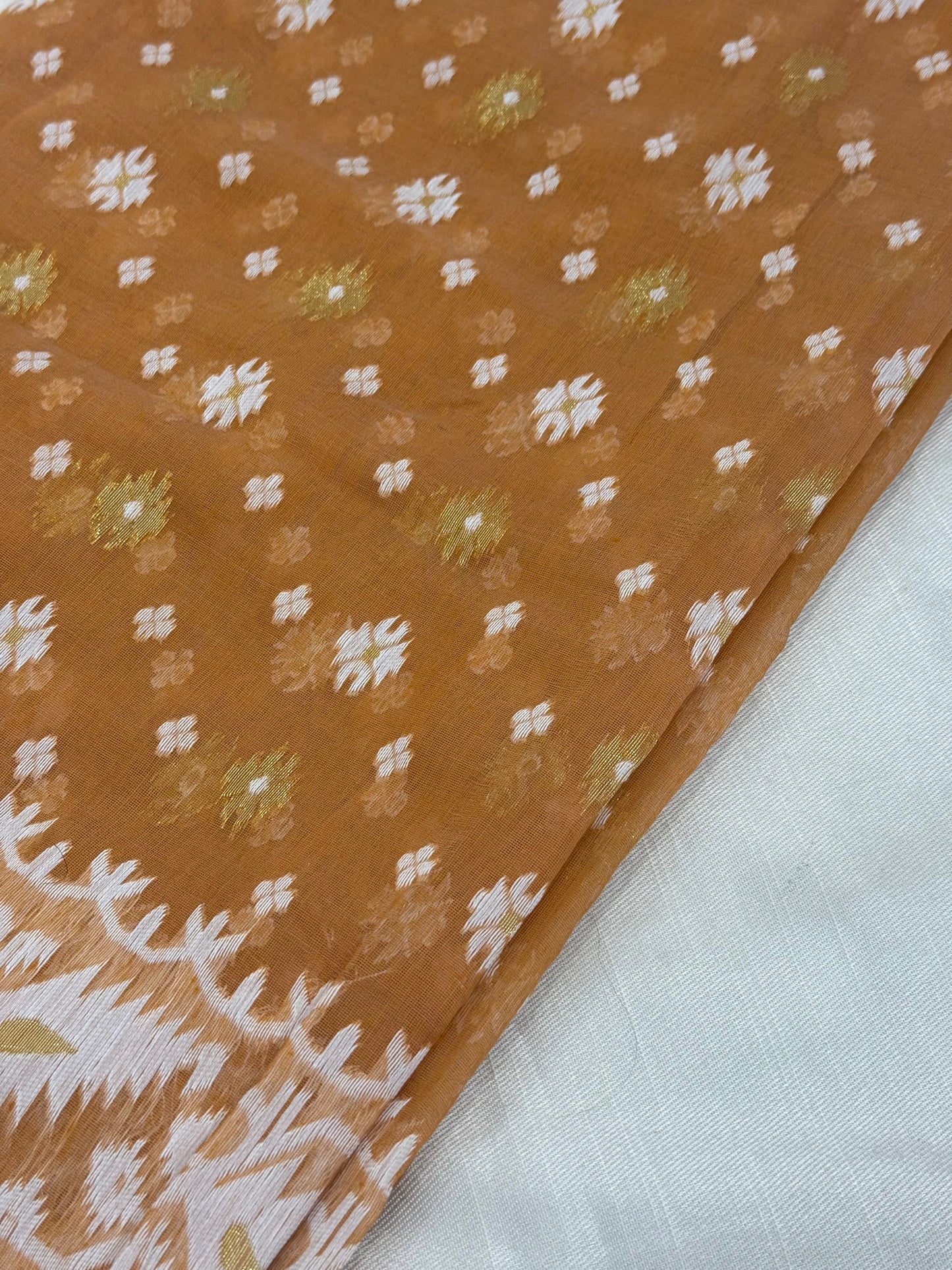 Border detail of handloom Jamdani saree with geometric vine and ivory motifs