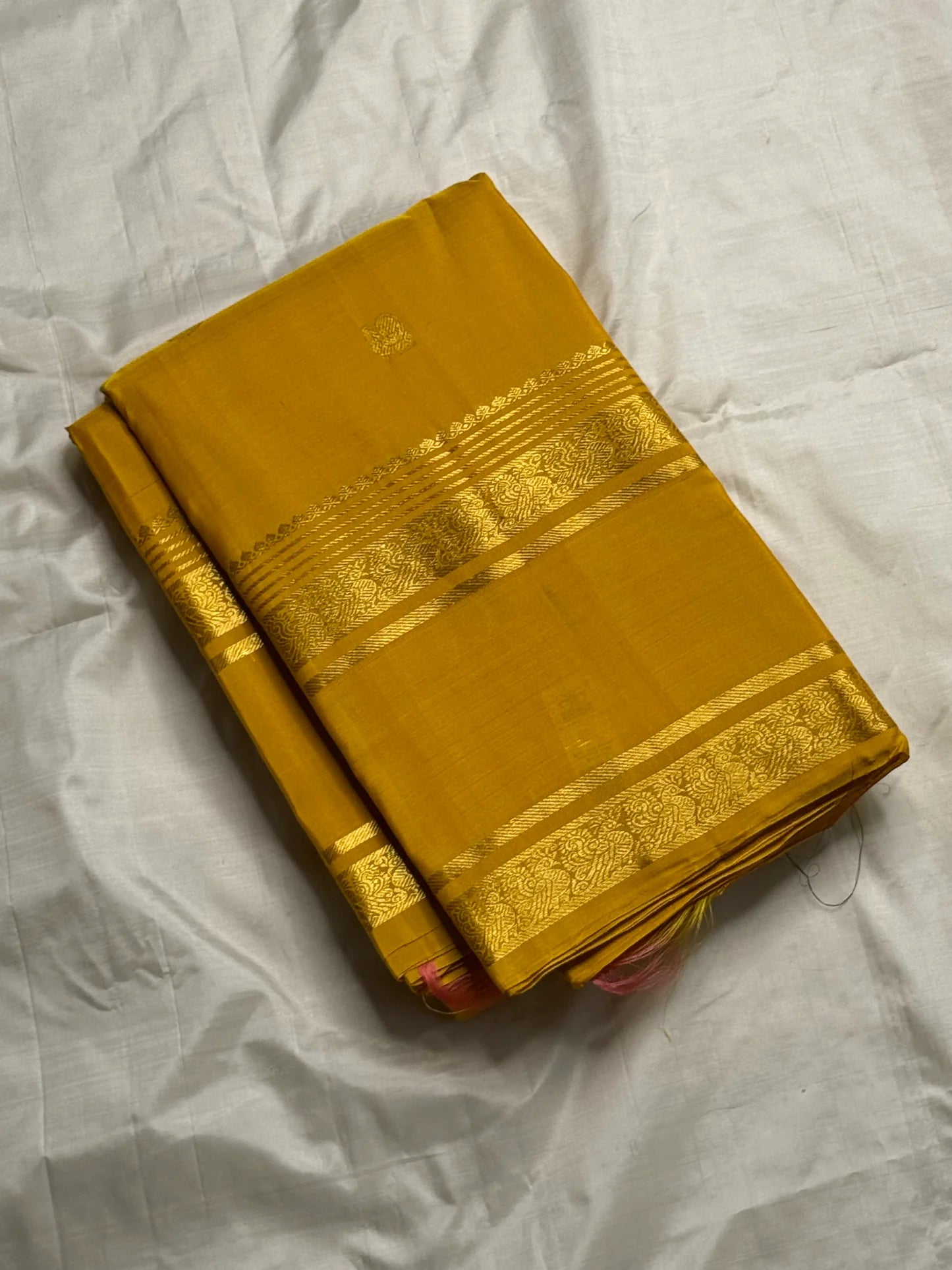 Kanakam mellow yellow body with zari rosette buttas and antique-gold borders; intricate pallu in diamond brocade with tassels.rose pink blouse 
Silk Mark Certified • Free Shipping within USA • Ships in Two Weeks ✅