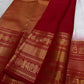 A true festival essential white with dashing red pure silk Kanchipuram saree with a kamalam and mayil detailed border zari work , red reku and Pallu