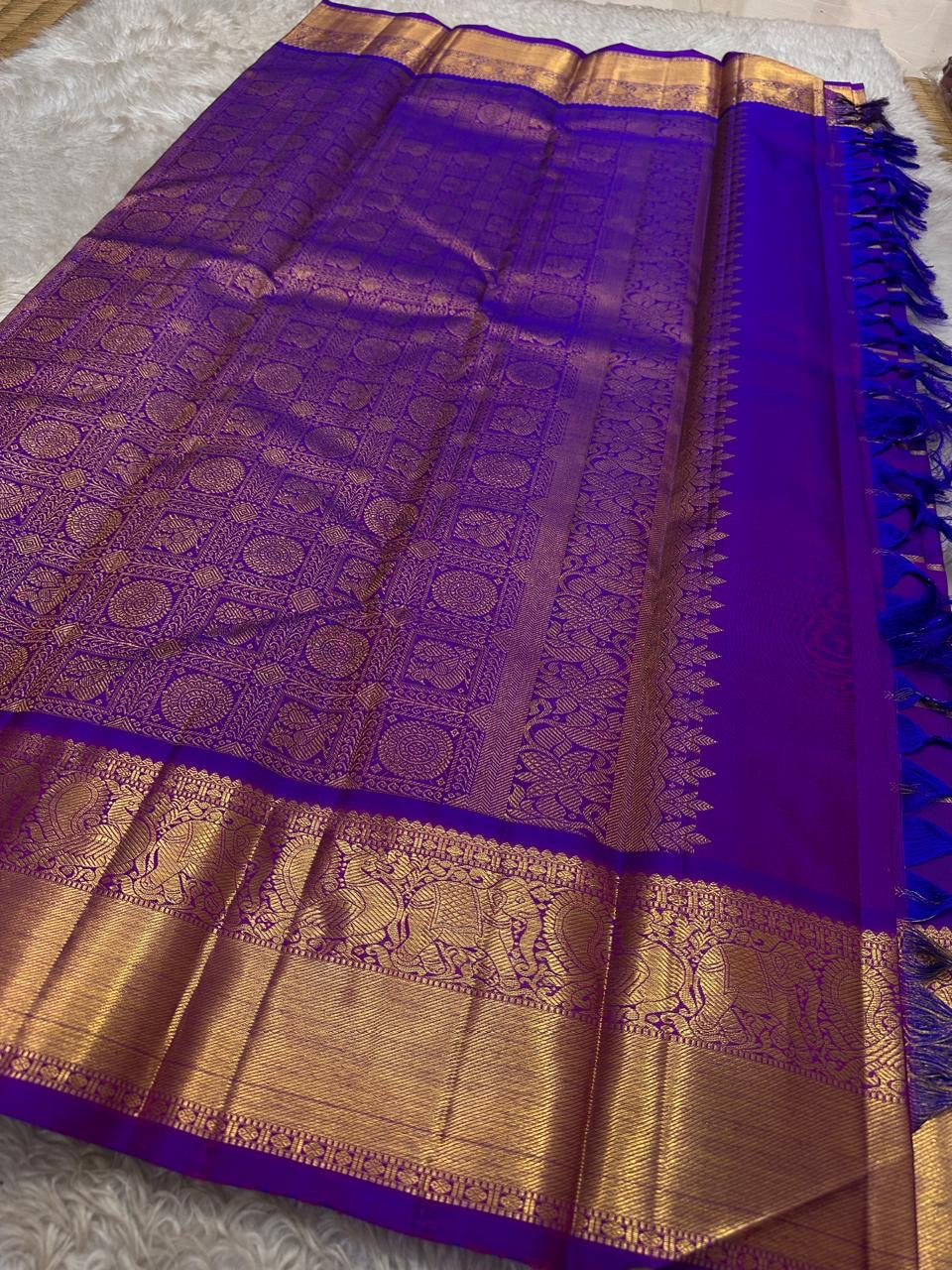 Leelavati Kattam
Amethyst Purple Kanchipuram Silk Saree
Zari-Woven Checks with Elephant Procession Border