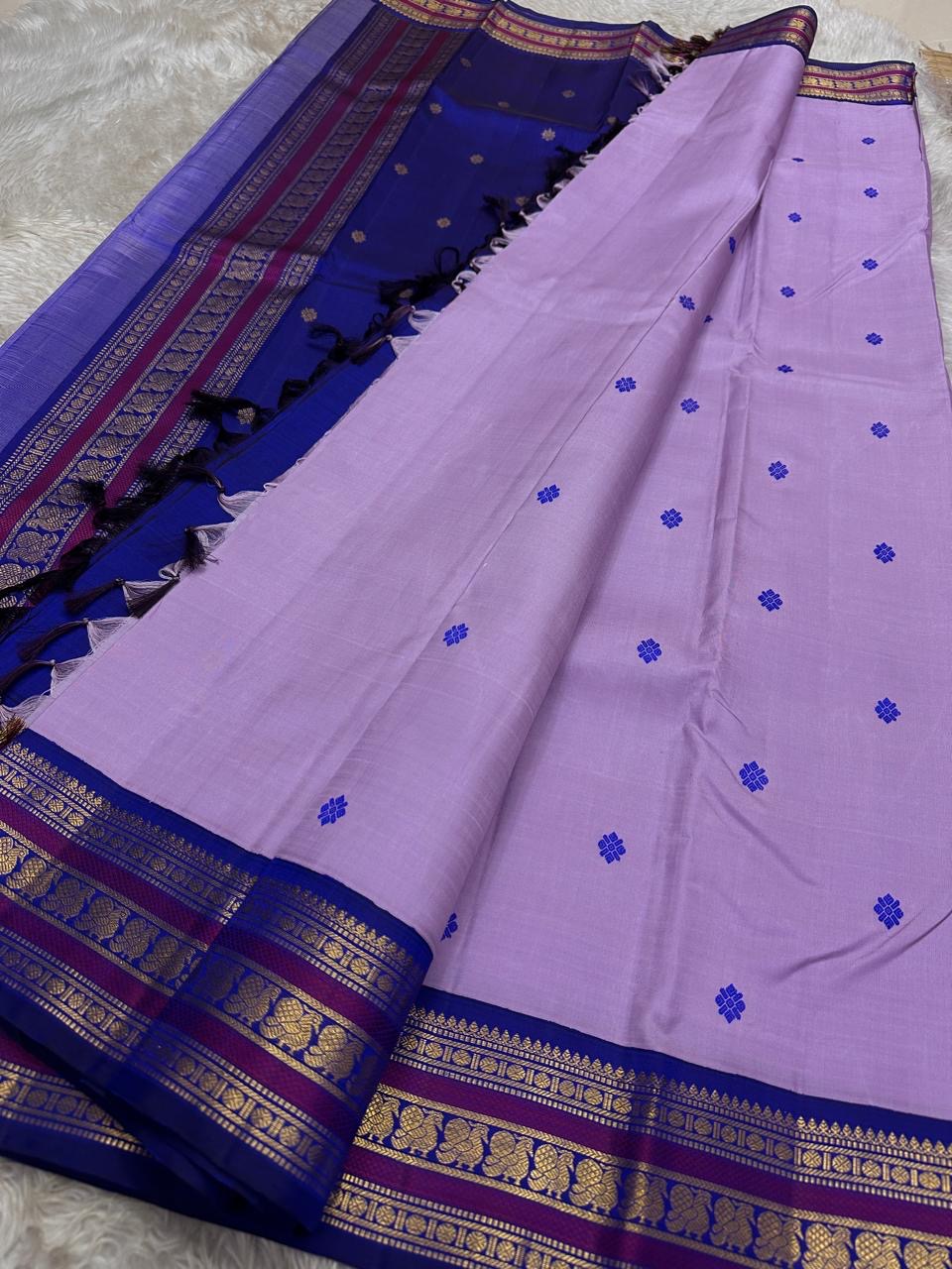 Lilac Indigo Pattu Butta — Pure Kanchipuram Silk Saree
Soft lilac body with indigo flower buttas, rich indigo–magenta gold zari borders and a grand indigo pallu.
Silk Mark Certified • Free Shipping within USA • Ships in Two Weeks