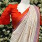 Tamara – Ivory Cream Semi-Silk Saree with Vibrant Orange Border
Paired with a Scallop Neck & Sleeve Ready-to-Wear Orange Blouse (Size 36–42)